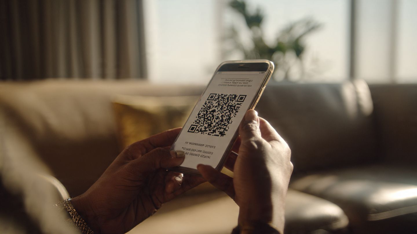 A close-up shot of a traveler scanning an eSIM QR code in an airport lounge, with soft daylight and a minimal, tech-focused aesthetic