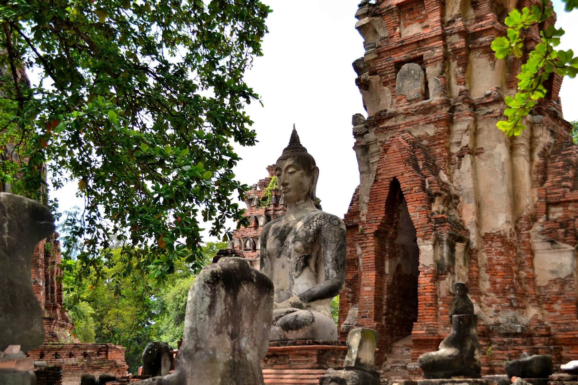 Ancient Buddha statue among the ruins of Wat Mahathat, Ayutthaya