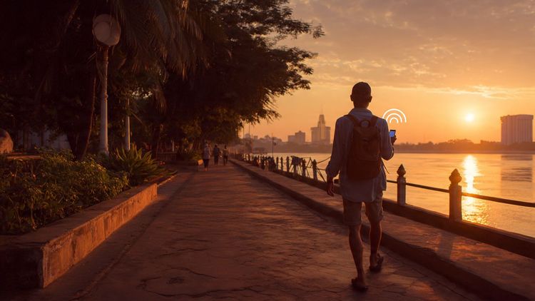 A traveler walking through Phnom Penh’s riverside at sunset, holding a smartphone with a secure connection indicator; cinematic lighting, warm travel aesthetics, safety-focused scene