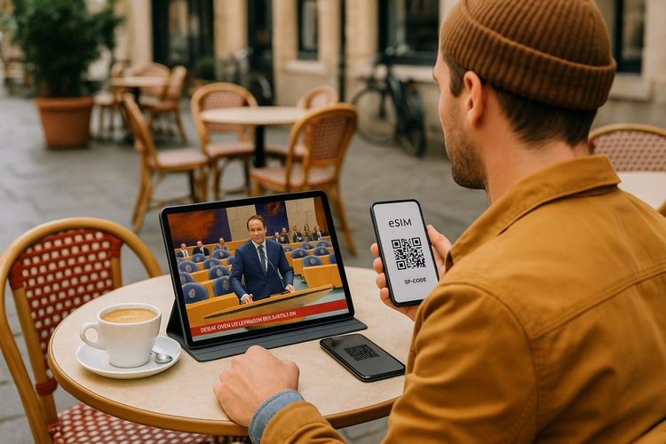A traveler sitting in a European café watching Dutch parliamentary news on a tablet,