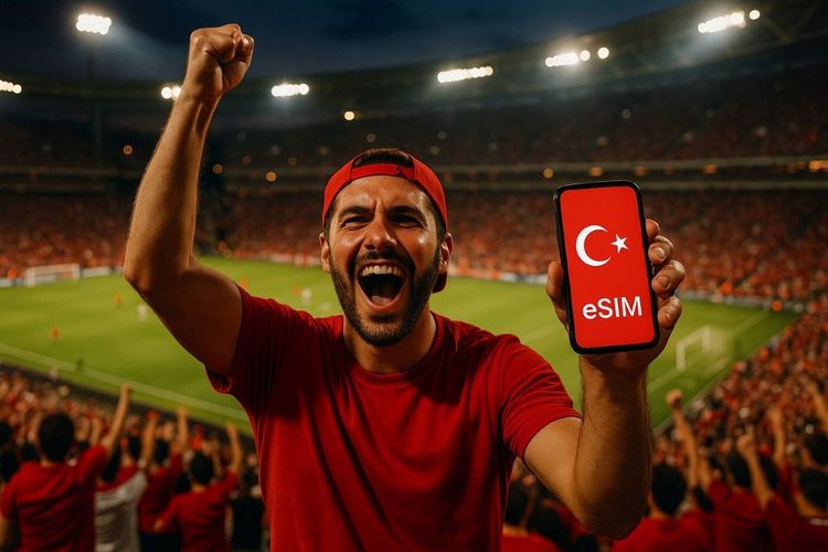 Football fan celebrating in Istanbul stadium stands, holding smartphone showing active Turkey eSIM connection