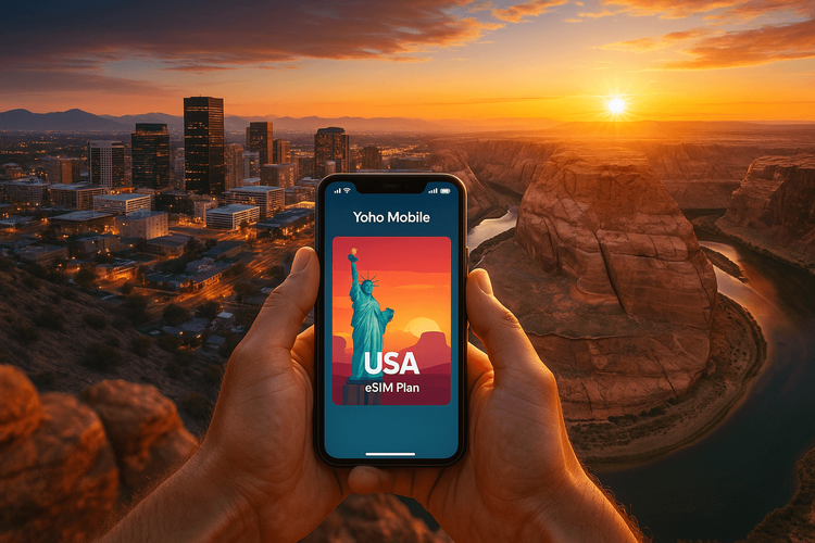 A traveler holding a phone with the Yoho Mobile USA eSIM app, with the Phoenix skyline and Grand Canyon in the background.