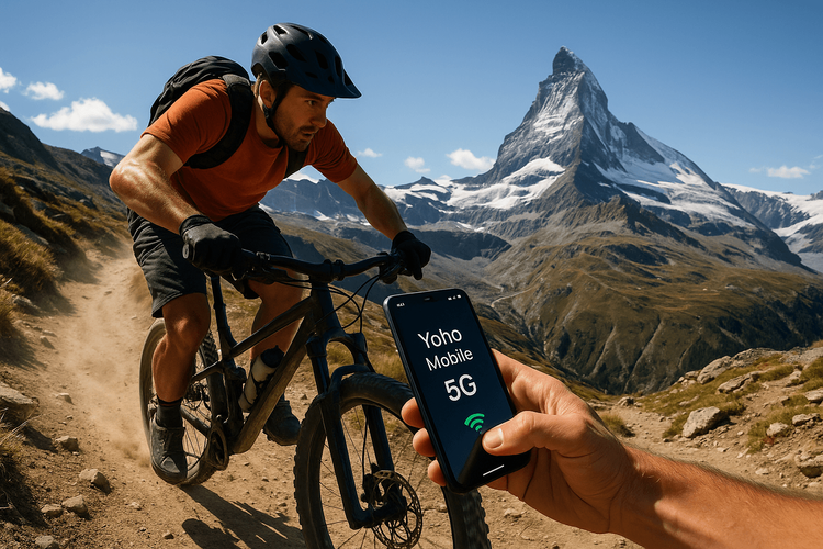 Mountain biker using a smartphone with Yoho Mobile eSIM signal at the 2025 MTB World Championships in the Swiss Alps.