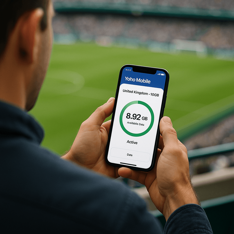A sports fan at a UK stadium checks their Yoho Mobile eSIM data plan on their smartphone.