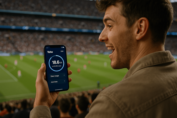 A football fan using a Yoho Mobile eSIM on their smartphone to stay connected at the Como vs Lazio Serie A match.