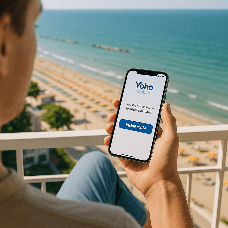 A traveler easily activating their Yoho Mobile eSIM on their phone with a view of Rimini, Italy in the background.