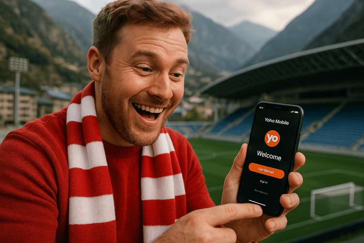 UK football fan using a Yoho Mobile eSIM on their phone before a match in Andorra.