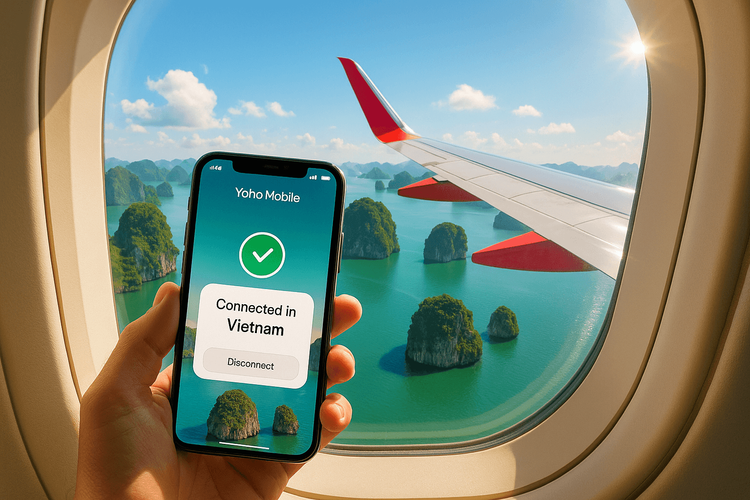 A phone showing Yoho Mobile eSIM connection with a view of Vietnam's Ha Long Bay from a Vietjet airplane window.