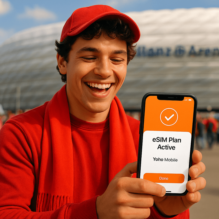 A football fan using a Yoho Mobile eSIM on their smartphone outside the Allianz Arena in Munich.