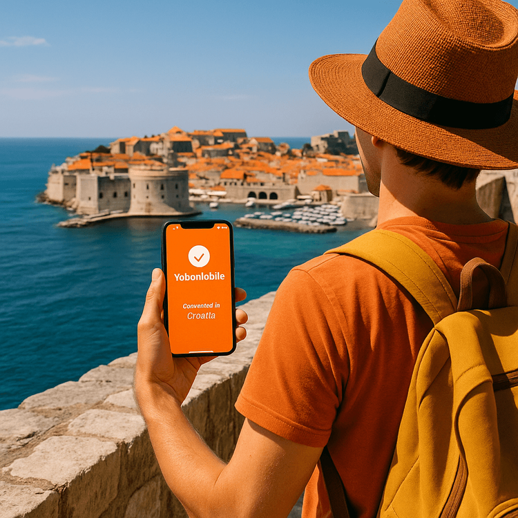 Traveler using a Yoho Mobile eSIM on their smartphone on the city walls of Dubrovnik, Croatia.