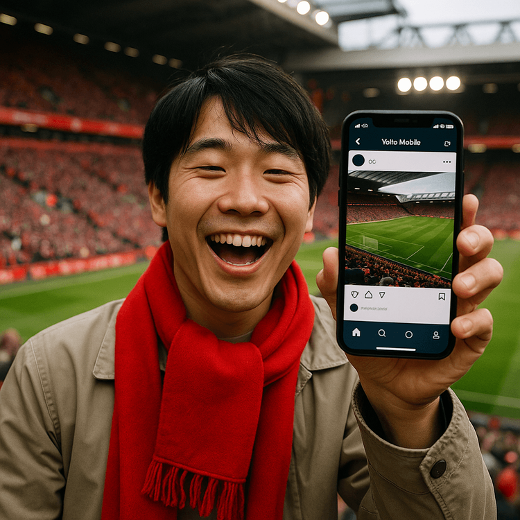 Japanese football fan at a Premier League match in the UK, using their phone with a stable Yoho Mobile eSIM connection.