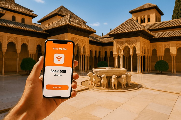 A traveler using a Yoho Mobile eSIM for Spain on their smartphone with the Alhambra palace in the background.