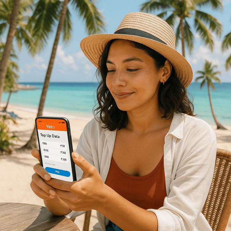 A traveler easily managing her Yoho Mobile eSIM data plan on her phone at a beach cafe in Cebu, Philippines.