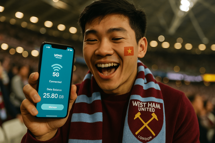 A Vietnamese West Ham fan using his Yoho Mobile eSIM on his phone to stay connected at London Stadium during a match.