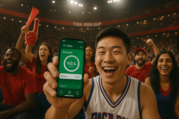A basketball fan at the FIBA Asia Cup 2025 in Saudi Arabia happily using their phone with Yoho Mobile eSIM to share the experience.