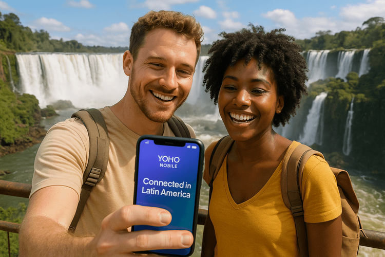 Happy travelers using a Yoho Mobile eSIM on their phone at Iguazu Falls, showcasing seamless connectivity in South America.