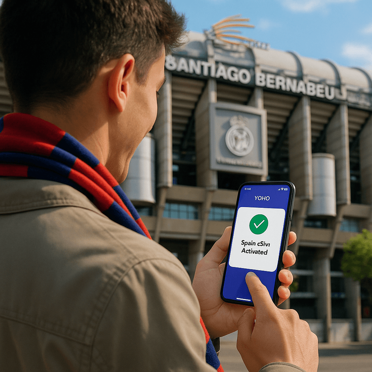 A football fan successfully activating their Yoho Mobile eSIM on a smartphone outside the Santiago Bernabéu stadium in Madrid.
