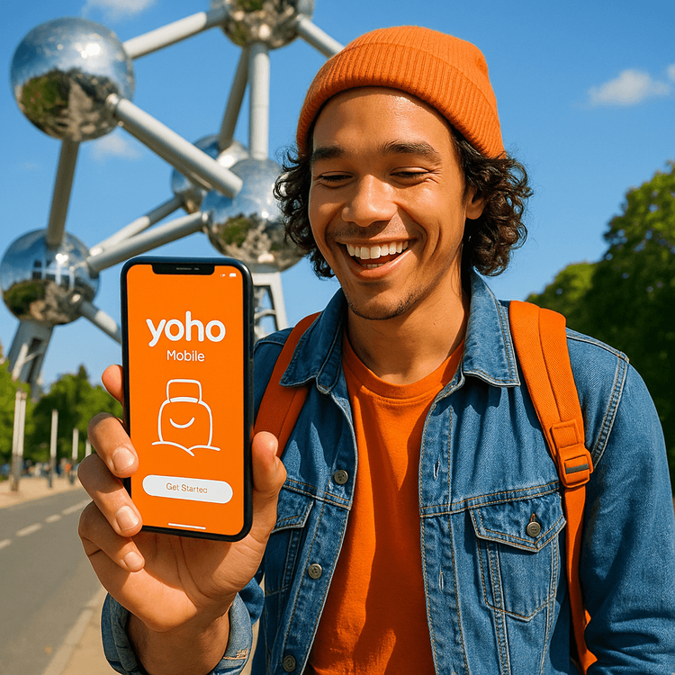 A traveler using a Yoho Mobile eSIM on their smartphone in front of the Atomium in Brussels, Belgium.