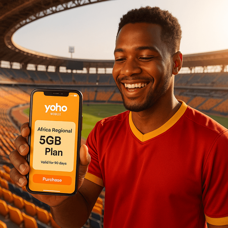 A football fan using a Yoho Mobile regional eSIM on their phone inside an African football stadium.