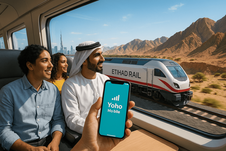 Travelers enjoying seamless connectivity on the Etihad Rail with Yoho Mobile eSIM.