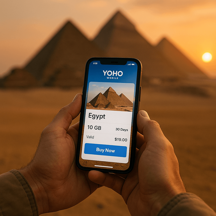 A traveler uses the Yoho Mobile app on their smartphone to manage their eSIM data plan with the Egyptian pyramids in the background.