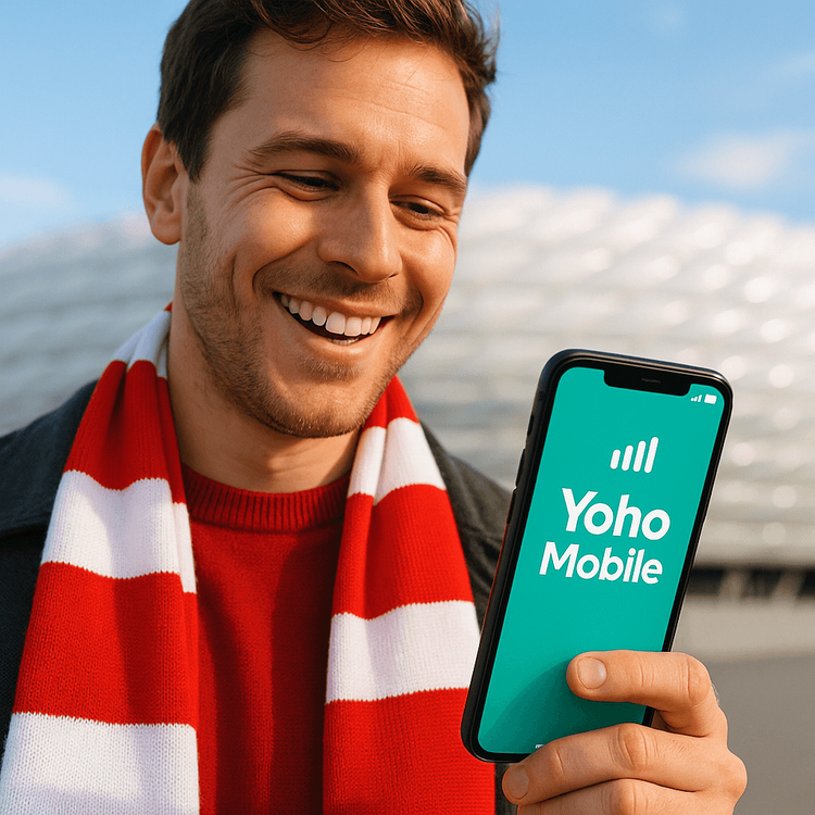 A football fan using a Yoho Mobile eSIM for connectivity at a Bundesliga match in Germany.