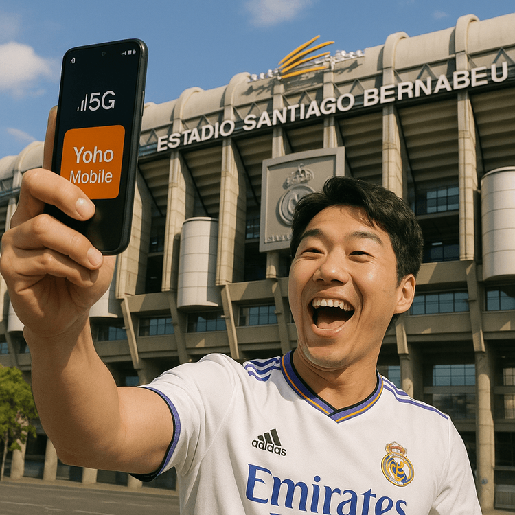 A Korean Real Madrid fan taking a selfie with full 5G signal on his phone outside the Santiago Bernabéu stadium.