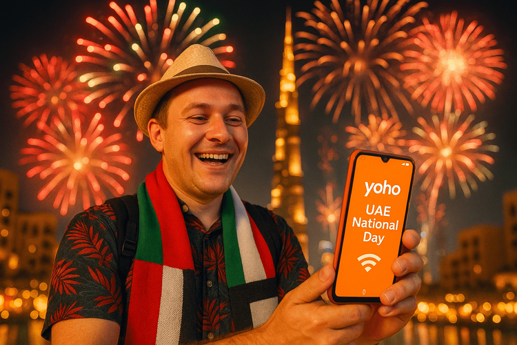 A tourist happily using their smartphone with Yoho Mobile eSIM during UAE National Day celebrations in Dubai.