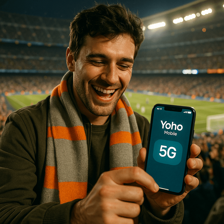 A football fan celebrating a goal at El Clásico while staying connected with a Yoho Mobile eSIM.