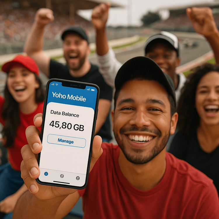 An F1 fan smiling and using their phone with the Yoho Mobile eSIM app interface visible, ensuring great connectivity at the racetrack.