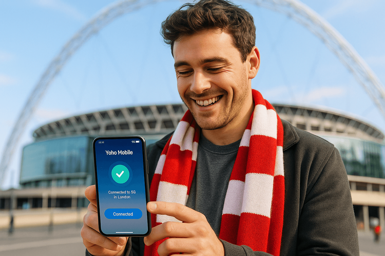 A football fan using a Yoho Mobile eSIM on their phone outside a UK stadium before the Carabao Cup final.