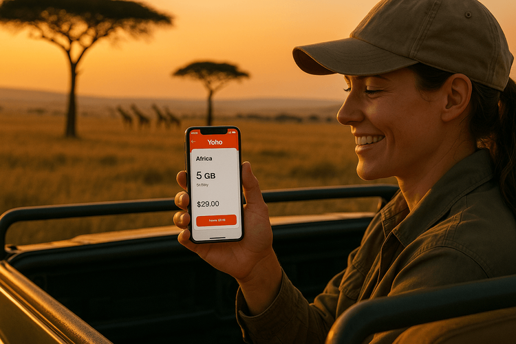 Traveler using a Yoho Mobile eSIM for Africa on their phone during a safari in Kenya.