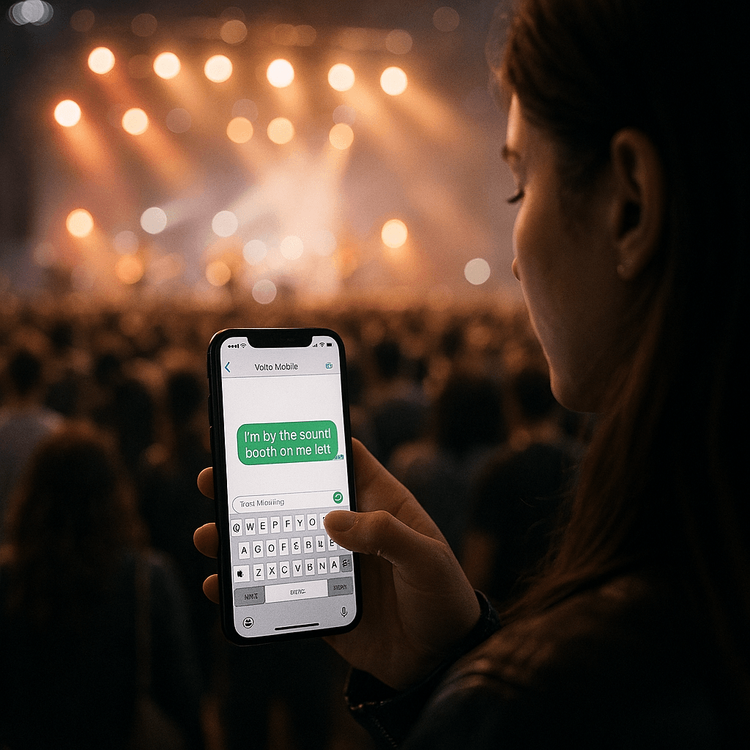 A fan easily messaging her friend at a crowded concert thanks to reliable mobile data from her Yoho Mobile eSIM.