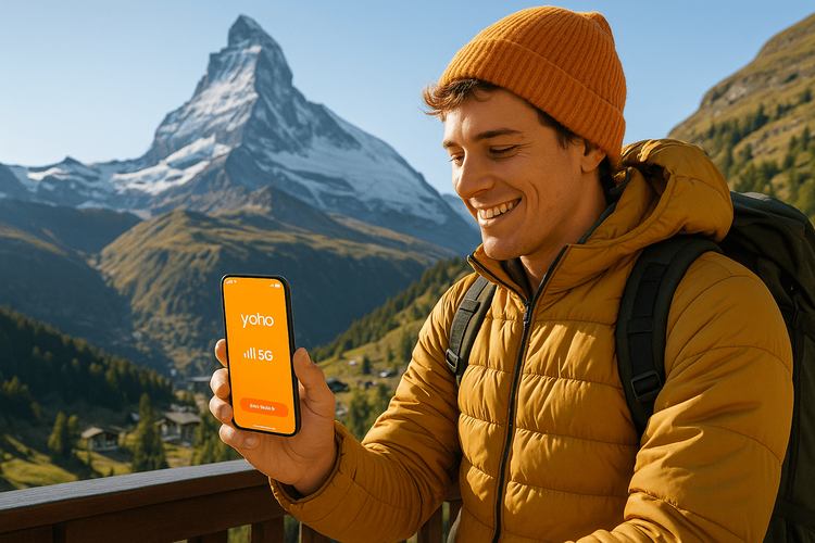 A traveler enjoying a seamless mobile connection with a Yoho Mobile eSIM in front of the Matterhorn in Switzerland.