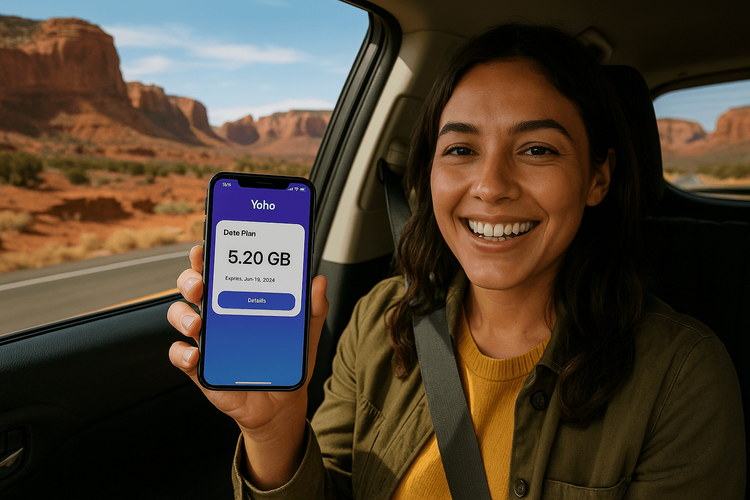 A woman happily using her Yoho Mobile eSIM hotspot in a car during a scenic road trip in the USA.