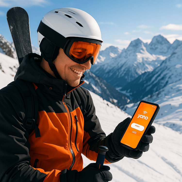 Skier using a Yoho Mobile eSIM to stay connected on the slopes of the Italian Alps.