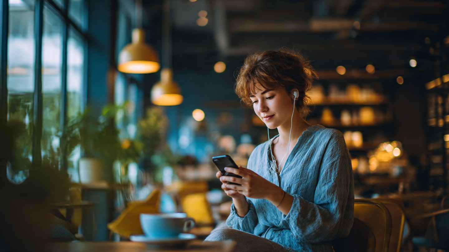 Person connecting securely in a café abroad using eSIM and VPN, modern cozy environment, calm mood